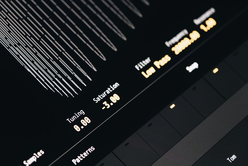 A broadcast mixing console with channel faders lit from beneath