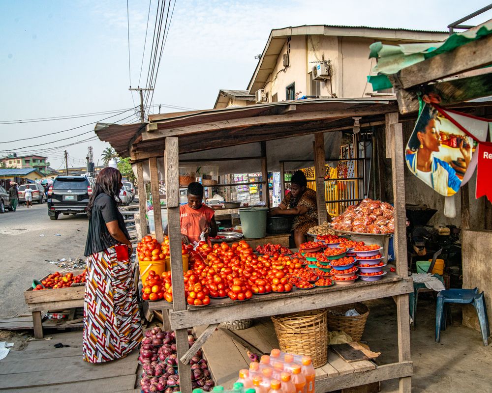 A roadside market stall with produce laid out in crates